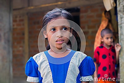 School going girl ready to go to school. Poor girl wearing blue school uniform is happy to get opportunity for girlsâ€™ education Editorial Stock Photo